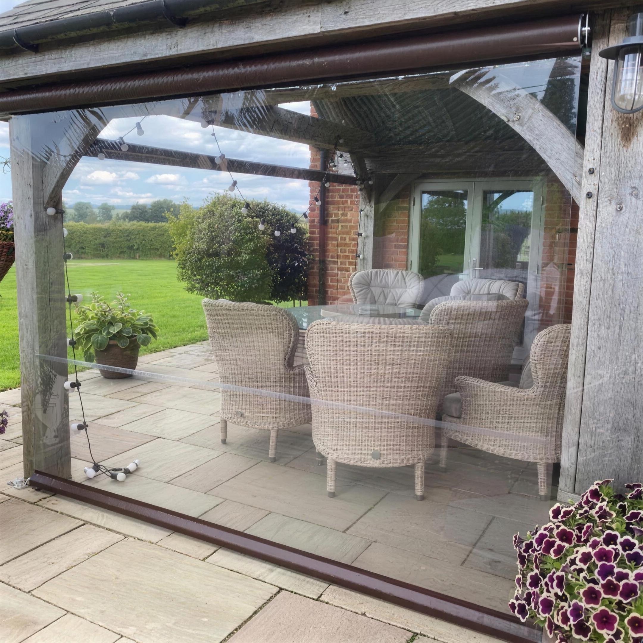 Clear roller blind keeping a pergola usable