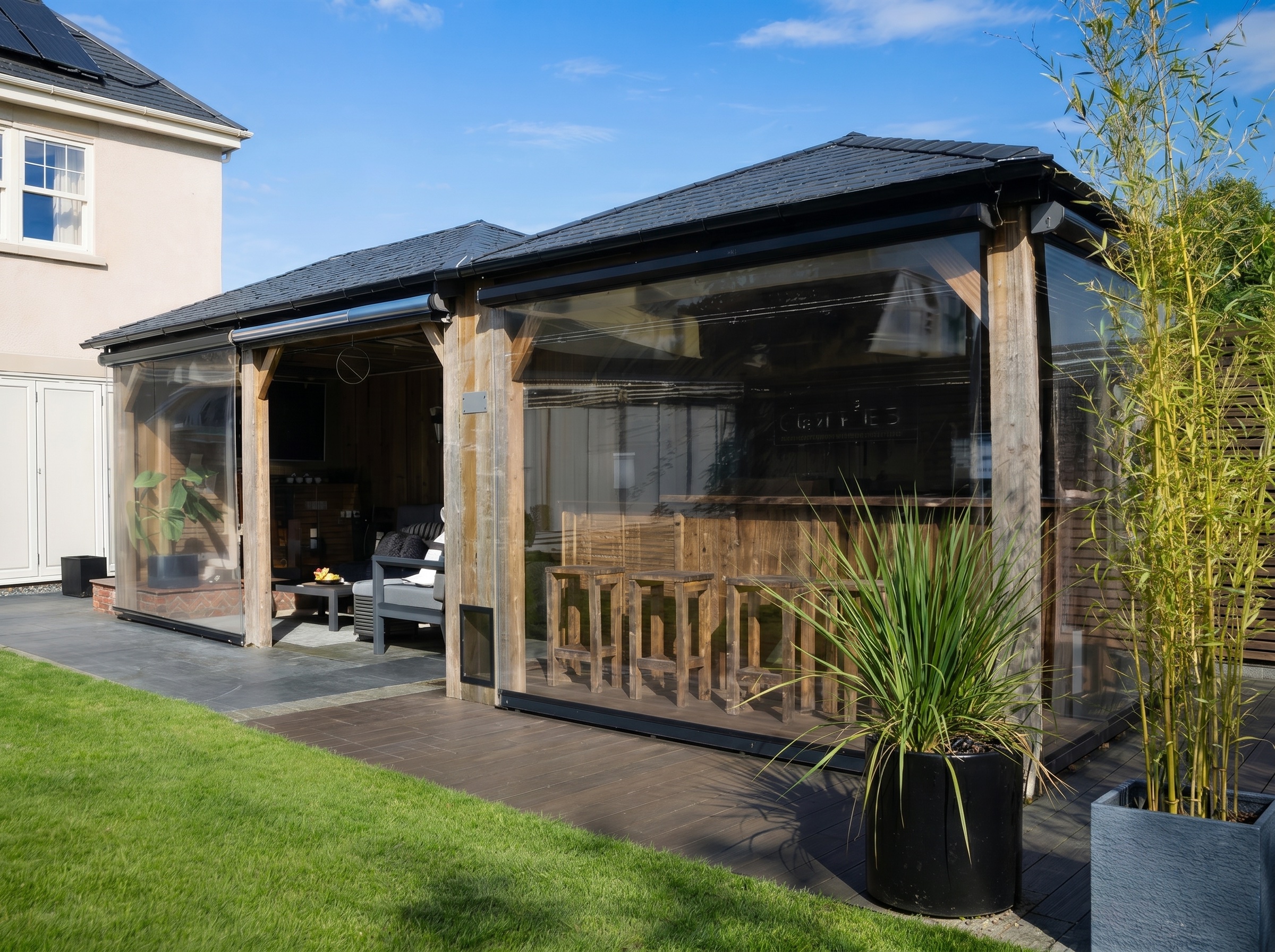 Clear PVC roller blind lowered on a garden pergola