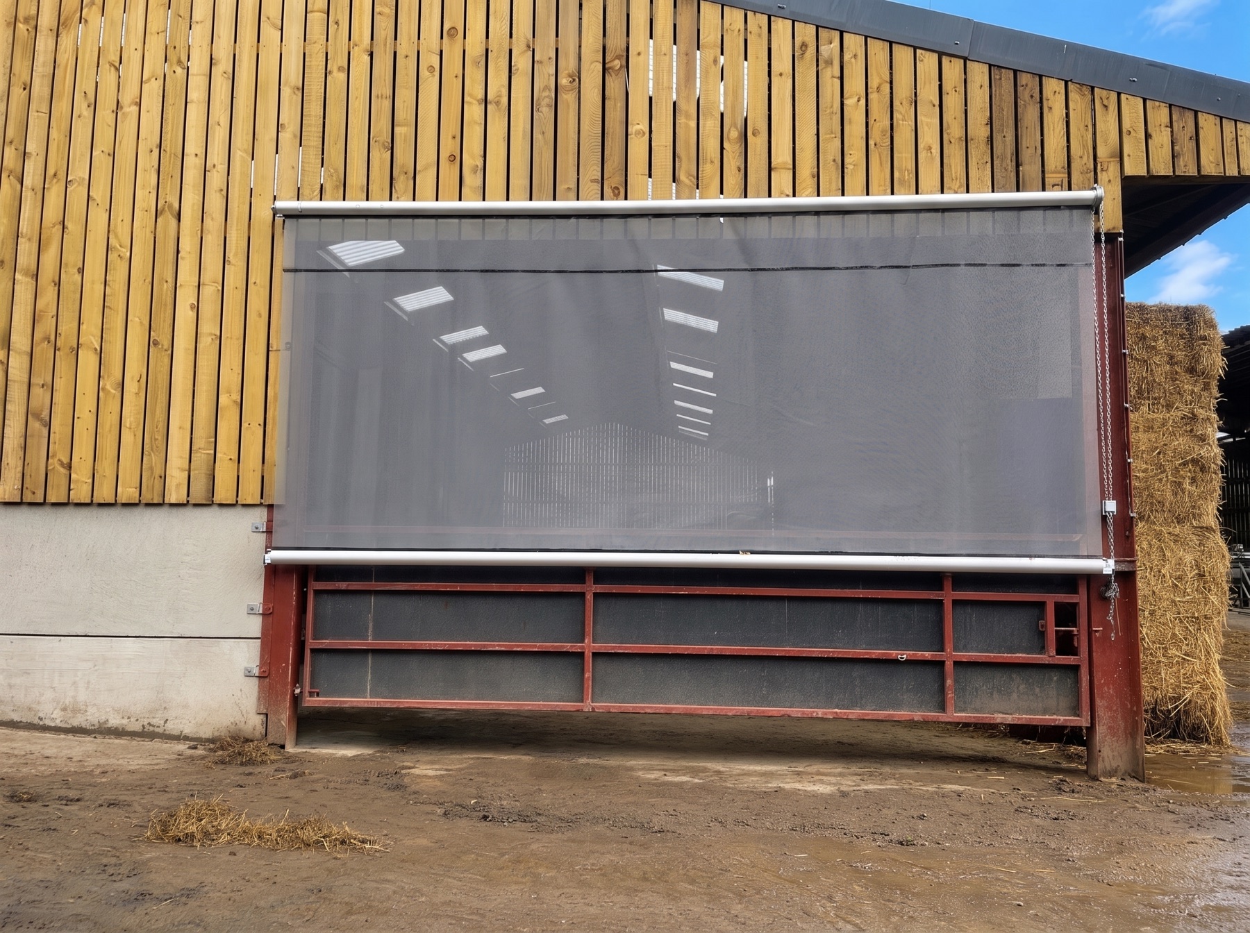 Chain roller blind covering a wide barn opening