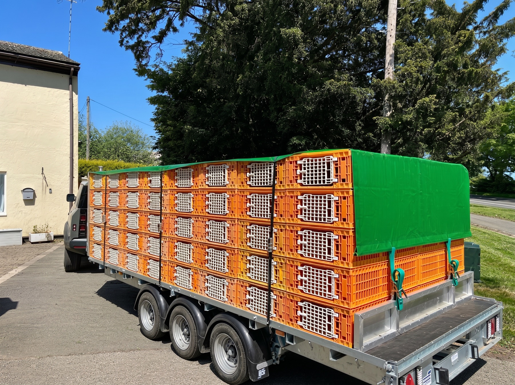 Trailer load of crates covered with a made to measure sheet, ready for the road