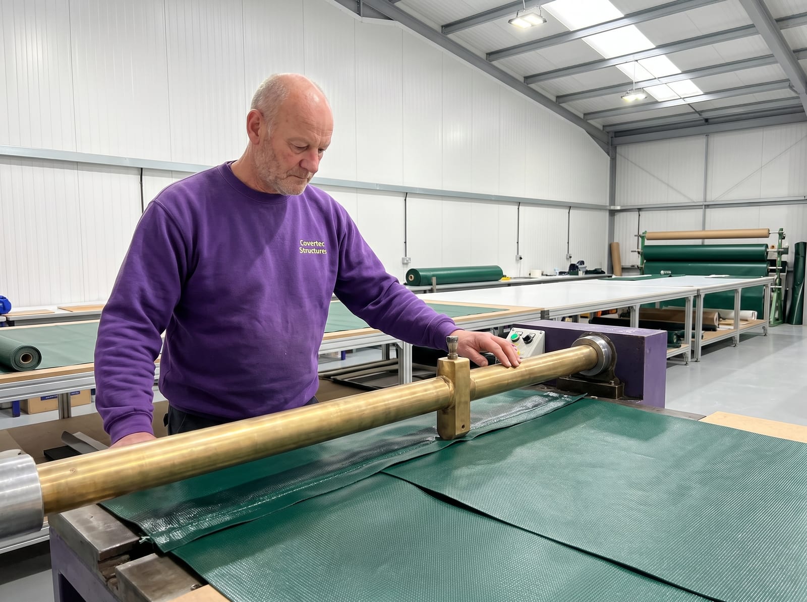 A Covertec craftsman welding a green PVC seam on the high frequency welding machine